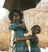Girl & Boy holding umbrella bronze statue