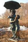 Girl & Boy holding umbrella bronze sculpture