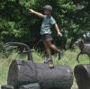 4 Kids on Logs bronze statue