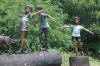4 Kids on Logs bronze sculpture