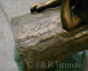 Three kids on log with squirrel bronze sculpture