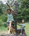 Kids with Water Pump bronze sculpture