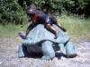 Two kids riding turtle bronze